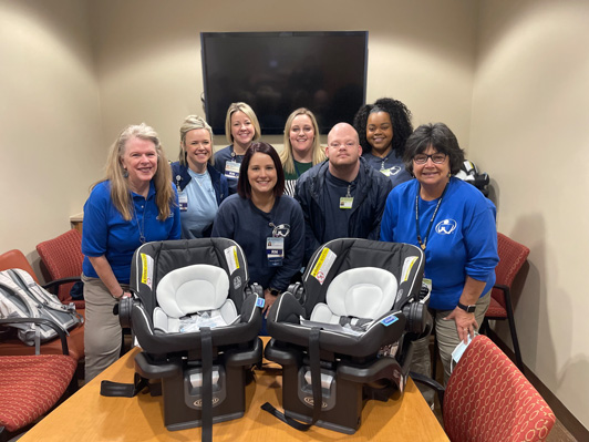 Volunteers with two new car seats