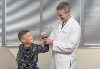 doctor performing sports physical
