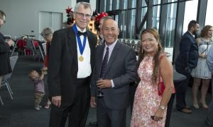 three people smiling at an event