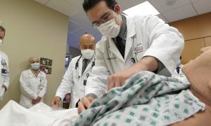 resident practicing a procedure on a medical dummy