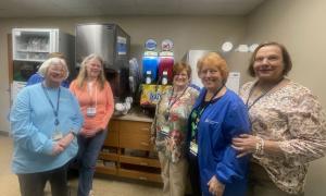 women in front of the slushie machine