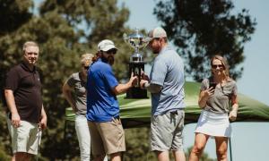 group holding a trophy