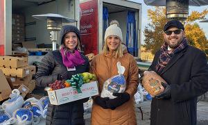 volunteers handing out holiday gifts