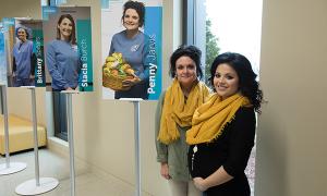 team members in front of their award posters